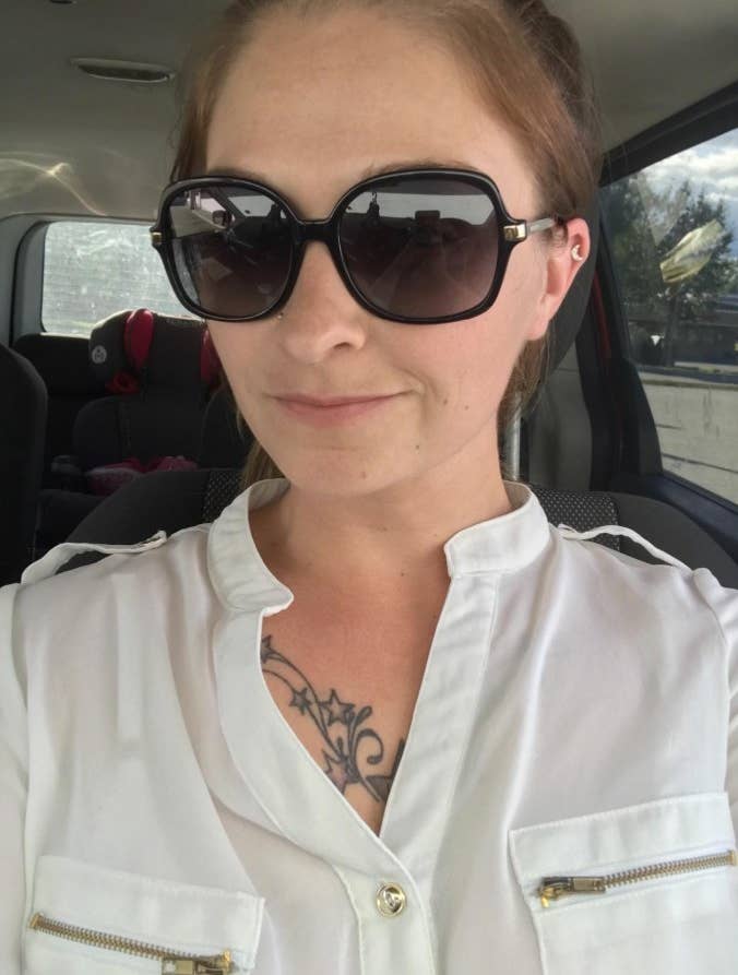 A reviewer wearing black sunglasses with a white top