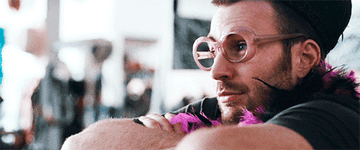 Chris Evans wearing a boa and goofy glasses