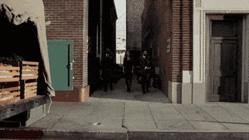 Three people walking in an alley in New York