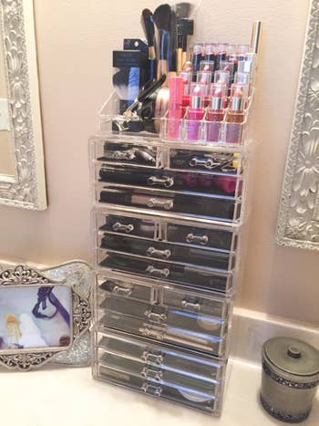 an extra tall makeup cabinet filled with makeup