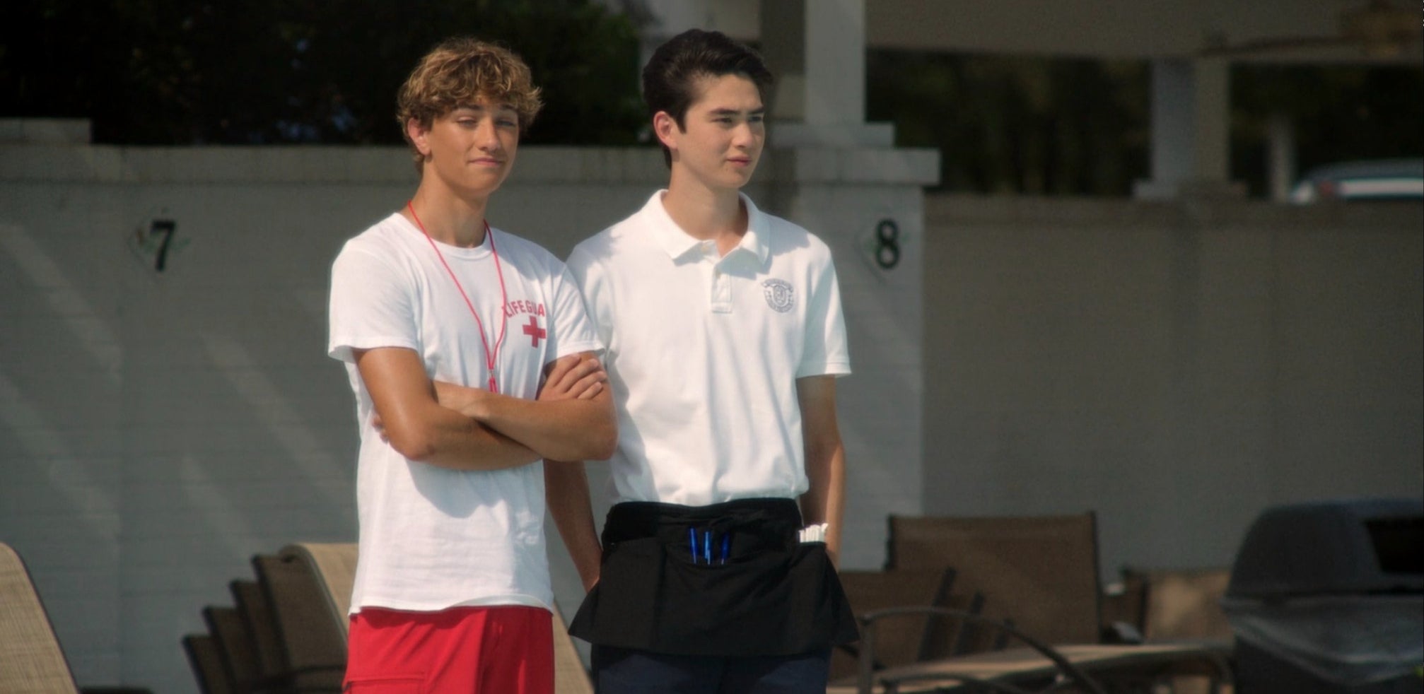 two of the boys in lifeguard and country club uniforms