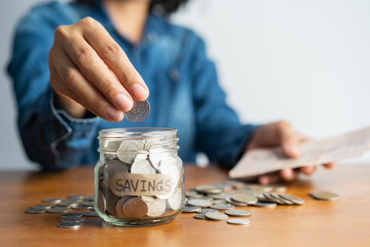 a jar of coins with the label &quot;Savings&quot; on it