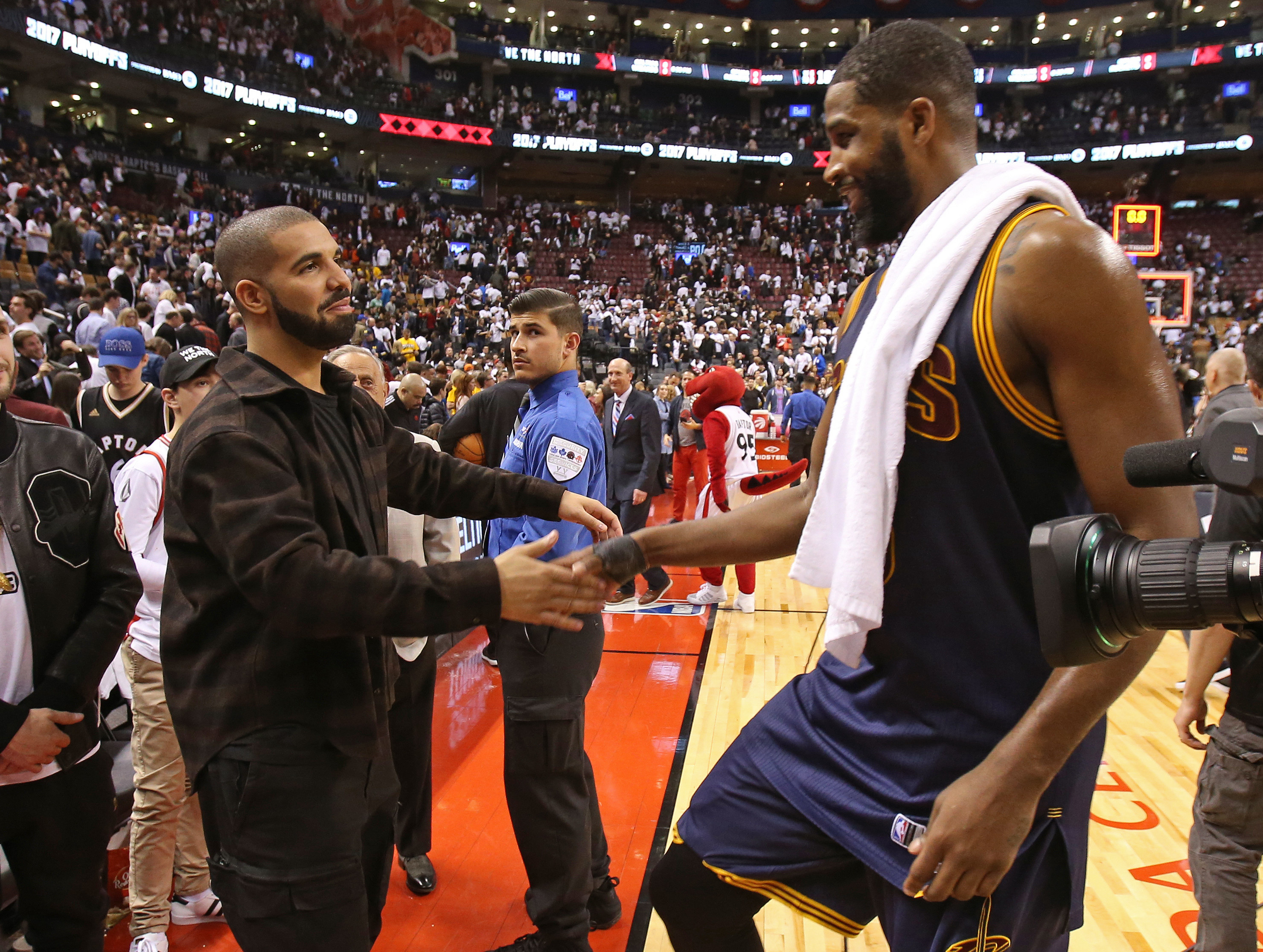 Drake shaking hands with Tristan Thompson