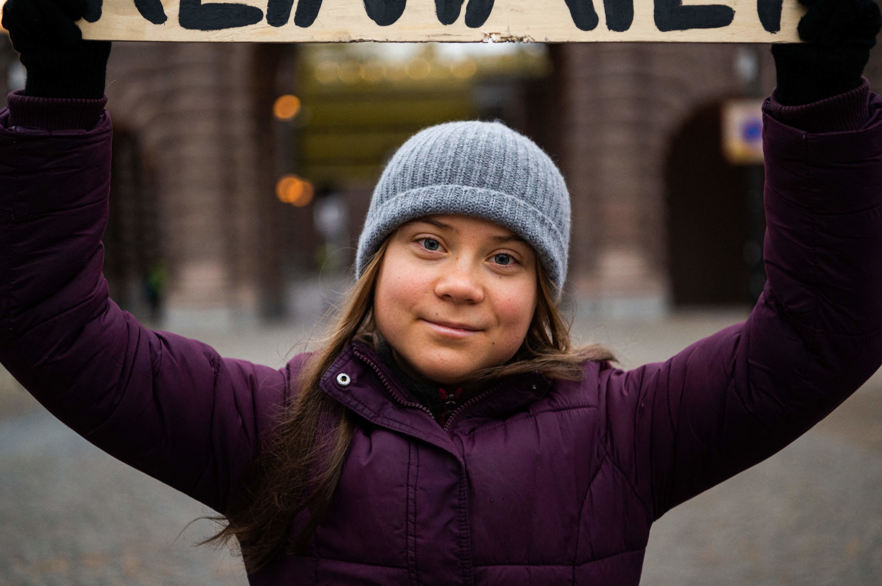 Swedish climate activist Greta Thunberg holding a sign reading &#x27;School strike for Climate&#x27; as she protests in front of the Swedish Parliament