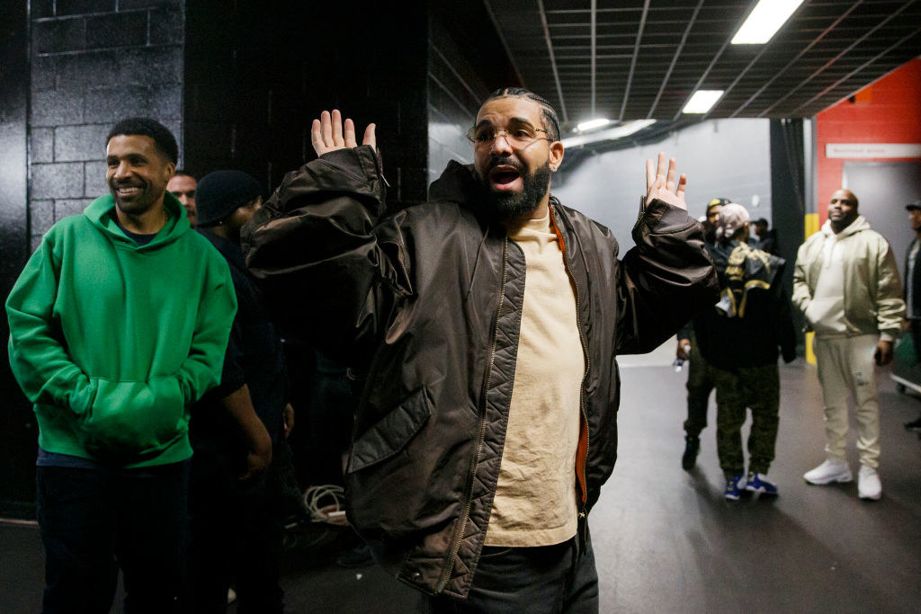 Drake backstage with his hands up.