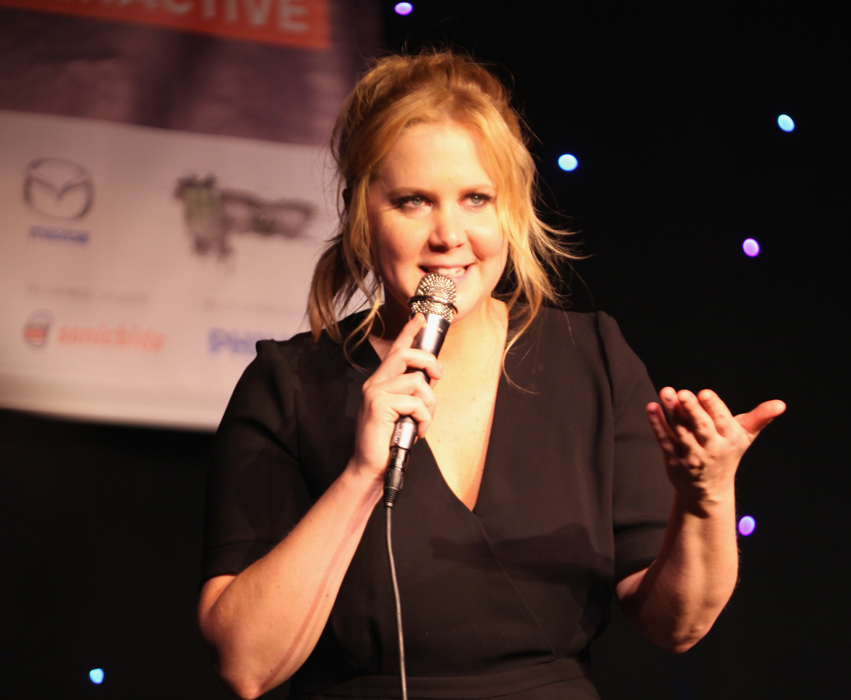 Amy Schumer performing standup onstage