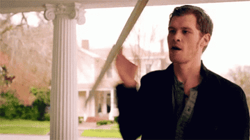 Klaus using a piece of wood as a weapon