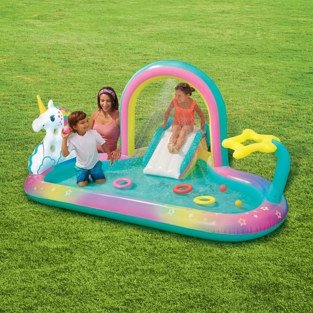 model and kids playing in pool outside on grass