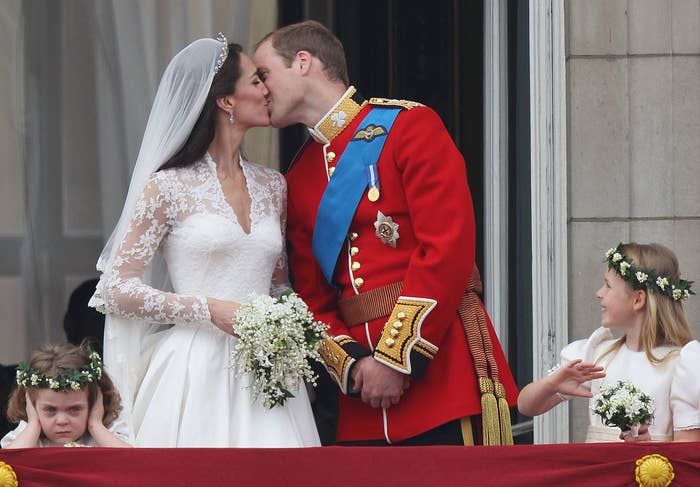 William and Kate continue kissing, but now one of the little girls looks angry and is covering her ears