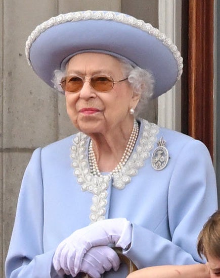A close-up of the queen, who is staring straight forward and paying no attention to Louis at her side