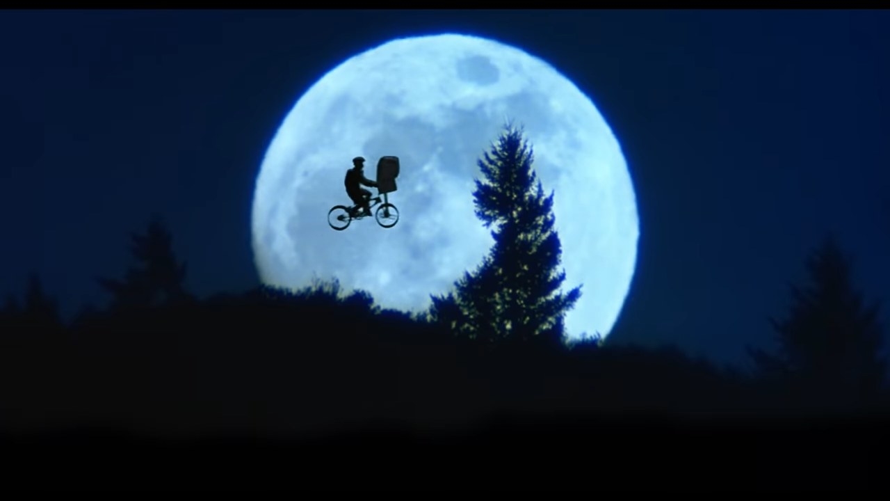 Elliot flying on his bike with E.T. with the moon in the sky in &quot;E.T. The Extra-Terrestrial&quot;