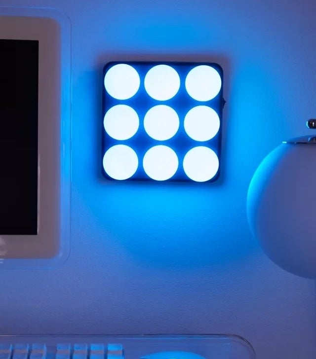 the colour-changing light panel mounted on a wall