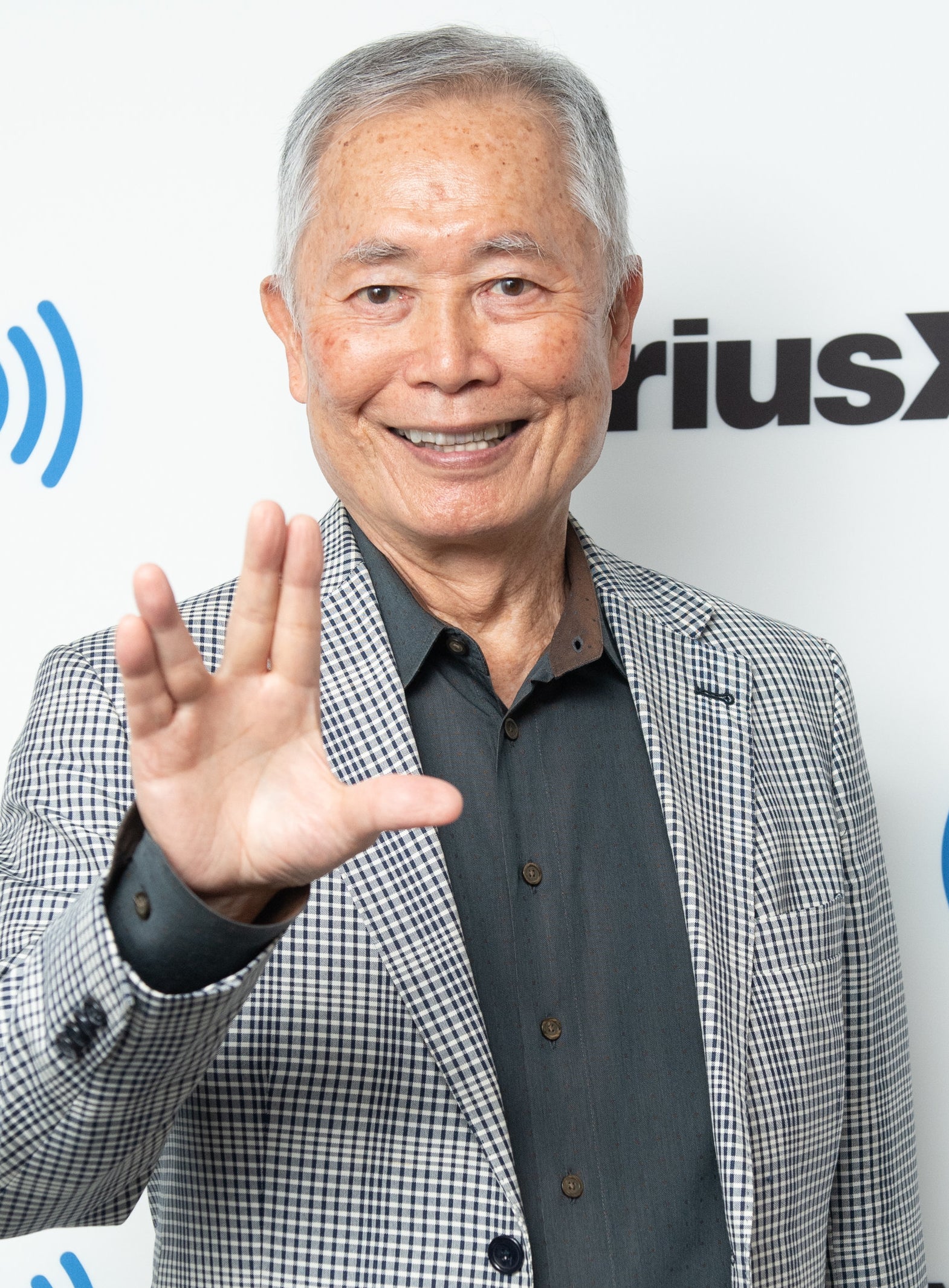 George Takei holding up the Star Trek sign