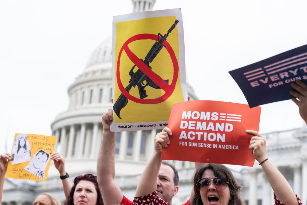 parents holding up anti-gun signs