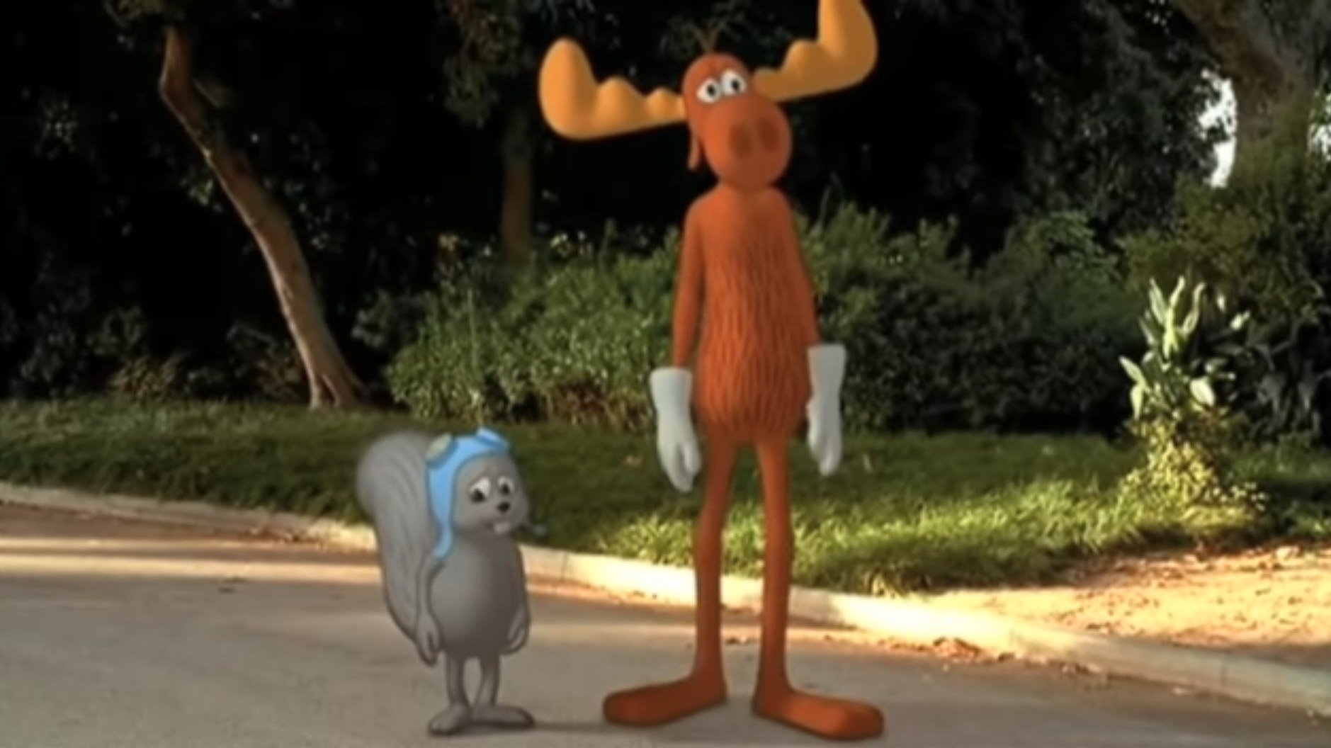 Rocky the flying squirrel and Bullwinkle the moose (both animated) stand in the middle of a real-life street