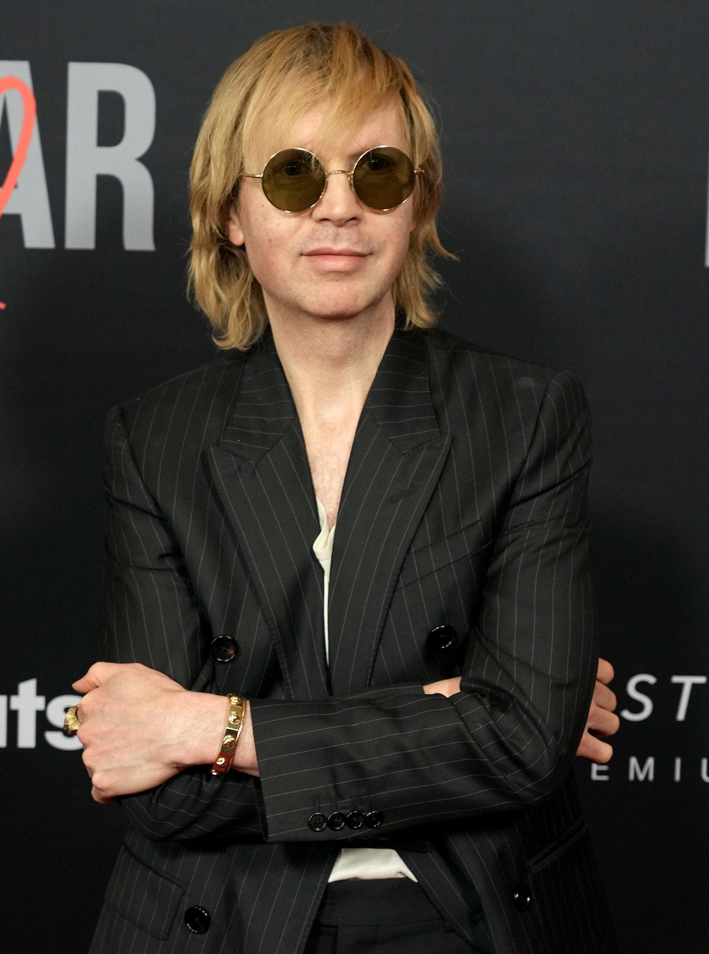 Beck in sunglasses and a suit