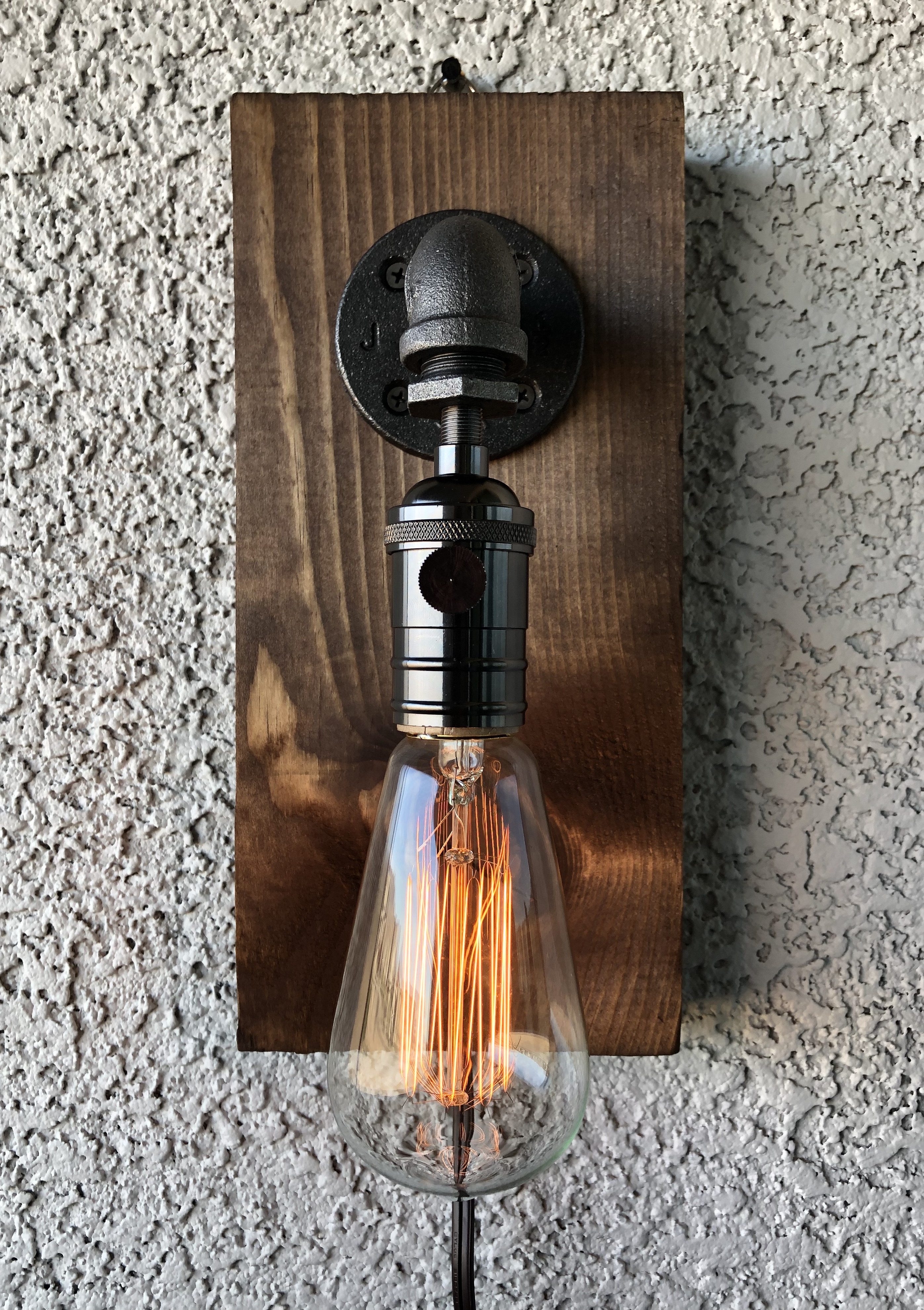 bare light sconce with edison bulb on the wall