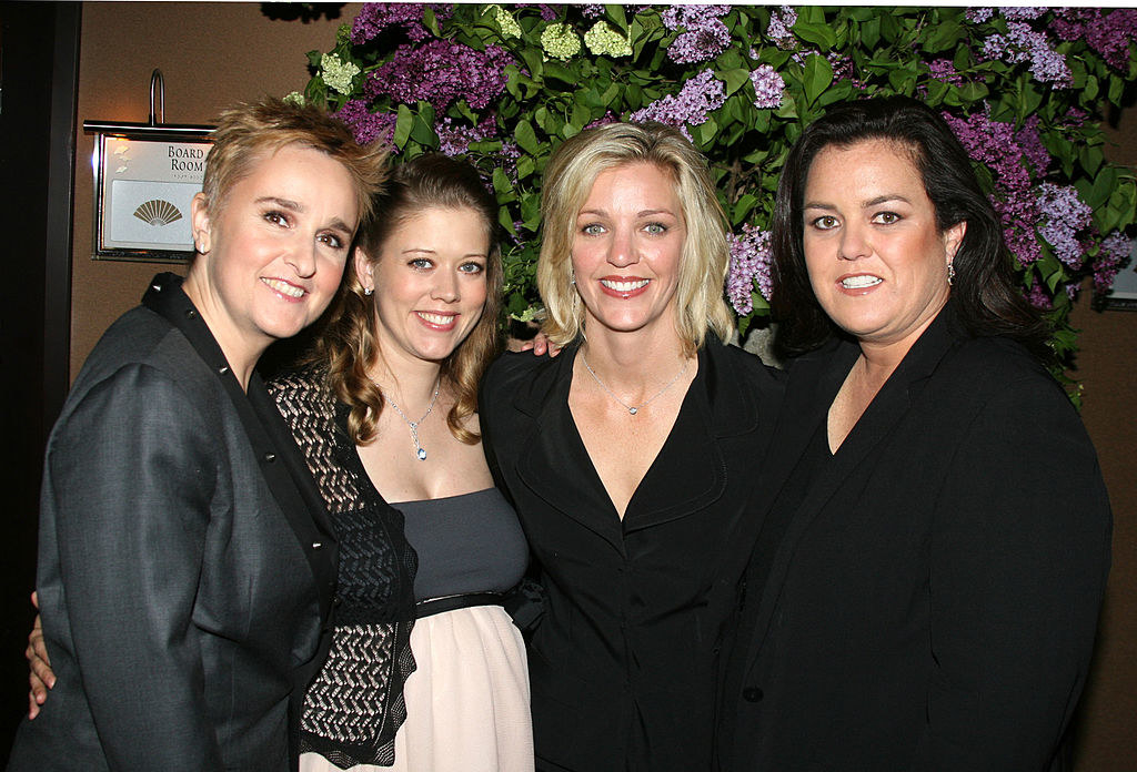 the four posing for a photo at an event