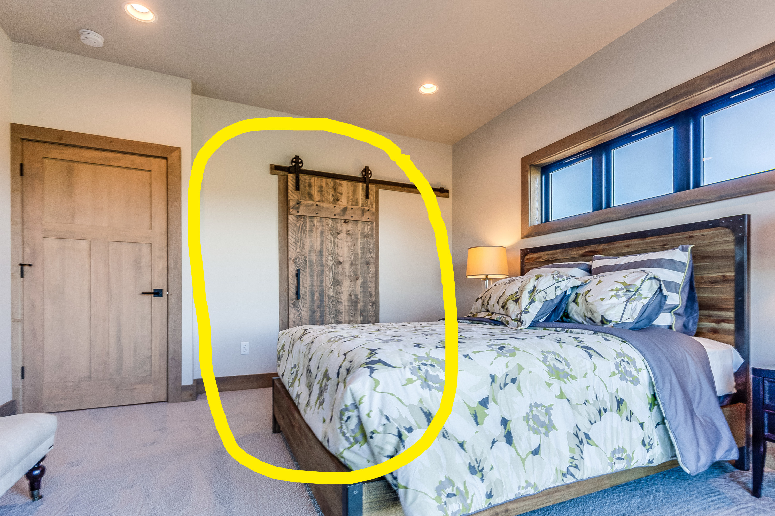 Barn door on bathroom in a main bedroom