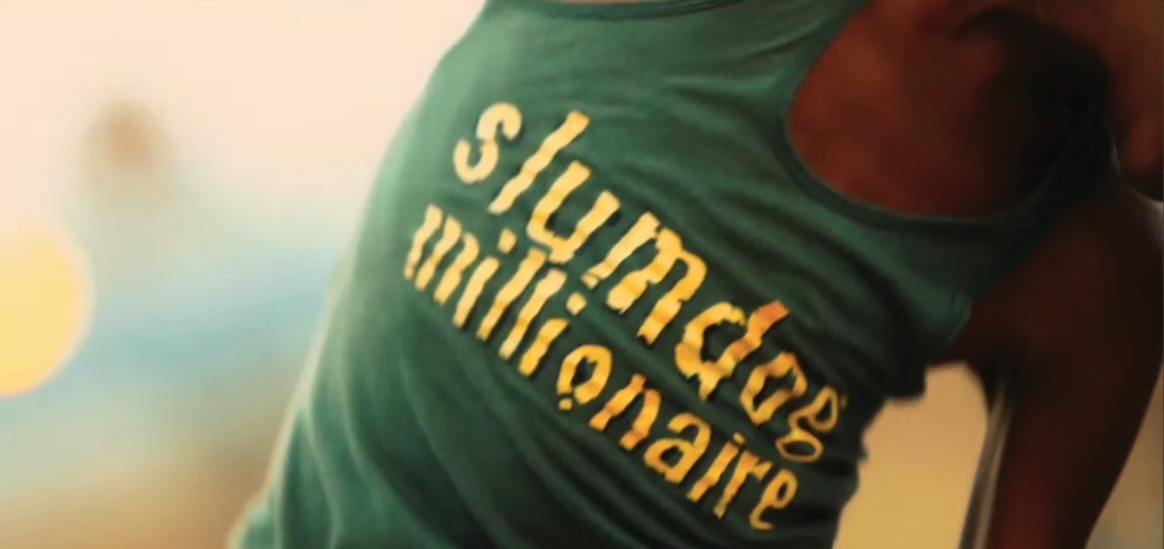 A young boy wears a shirt that says &quot;Slumdog Millionaire,&quot; which serves as the title card for the film&#x27;s trailer