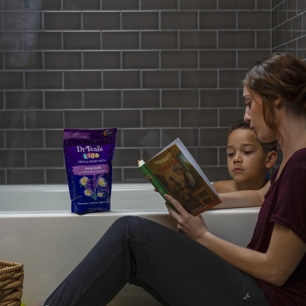 Mom reading to child in bath