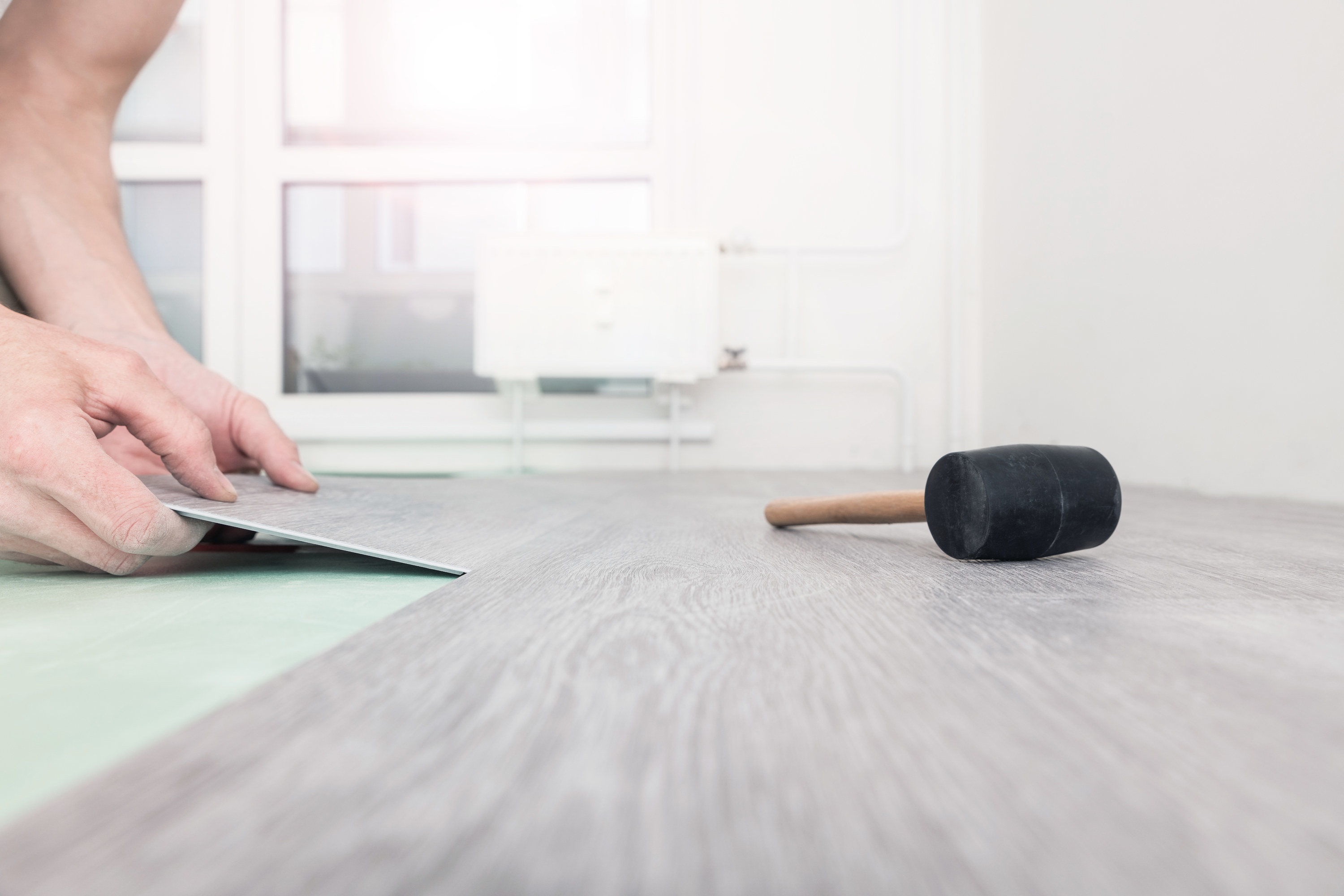 laying down vinyl wood gray flooring