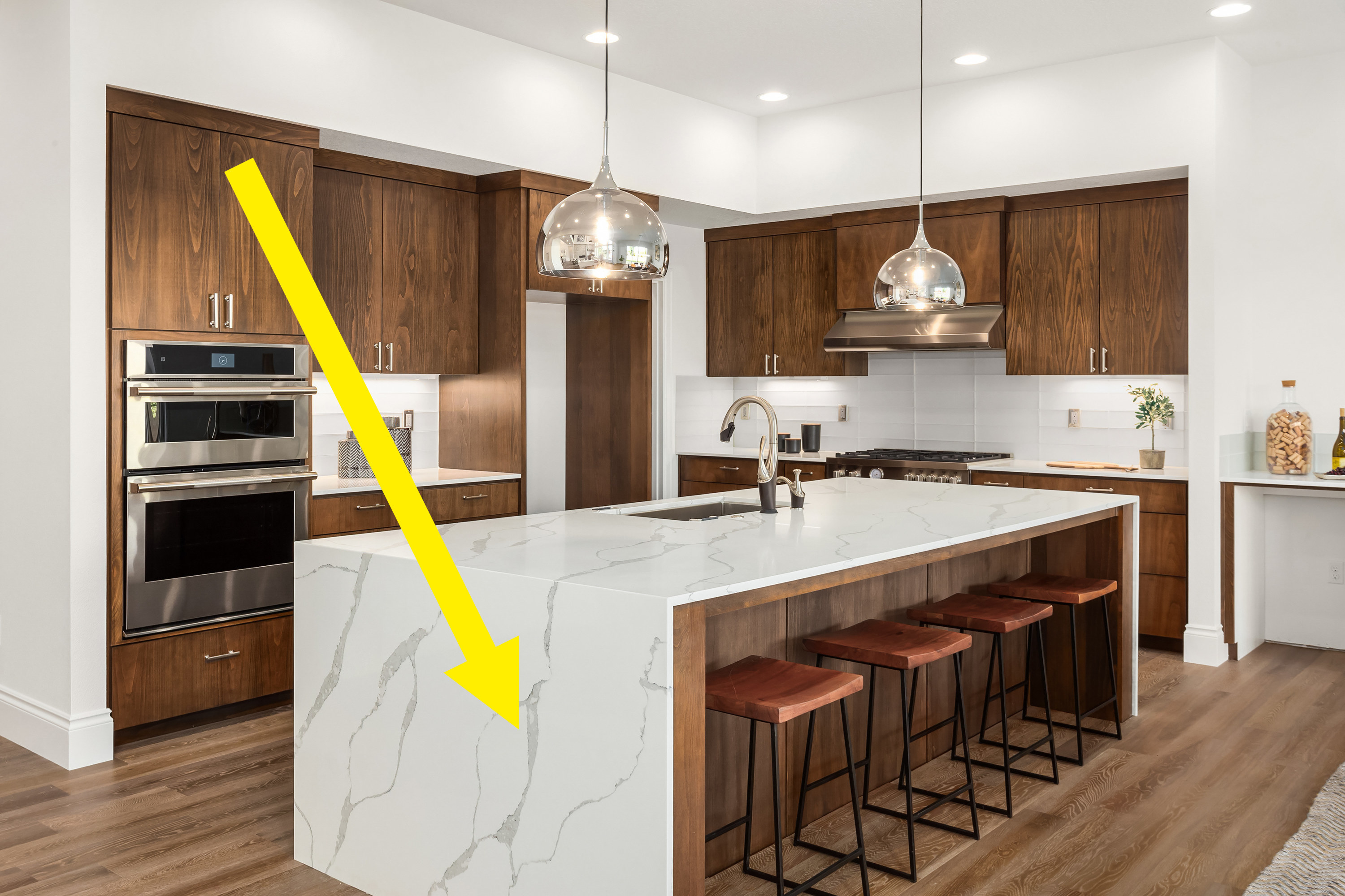 Gray vinyl flooring in a kitchen next to bar stools