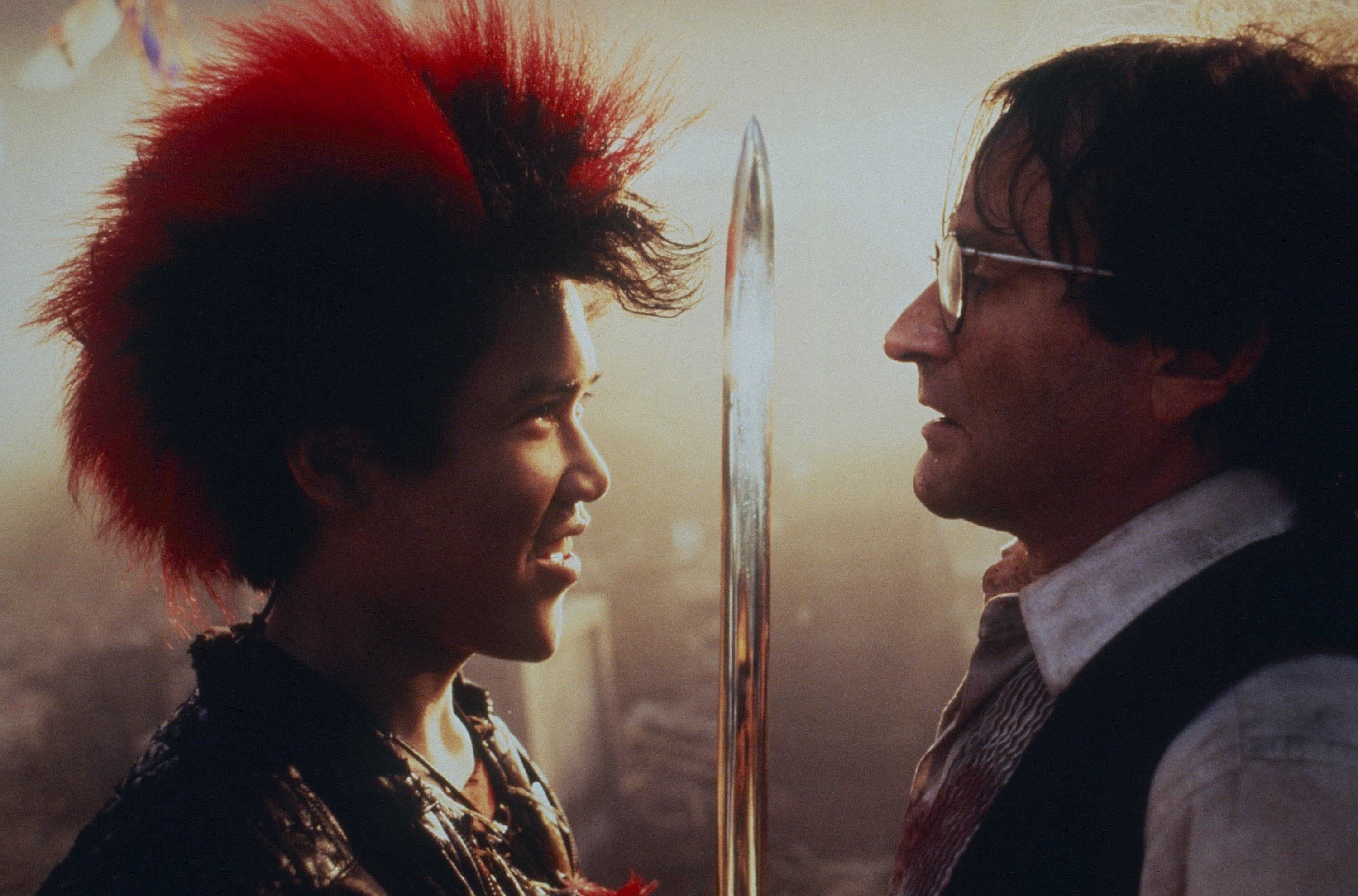 Dante Basco holding a sword between himself and Robin Williams
