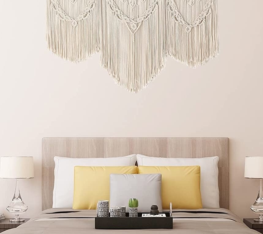 The wall hanging over a bed in a bedroom