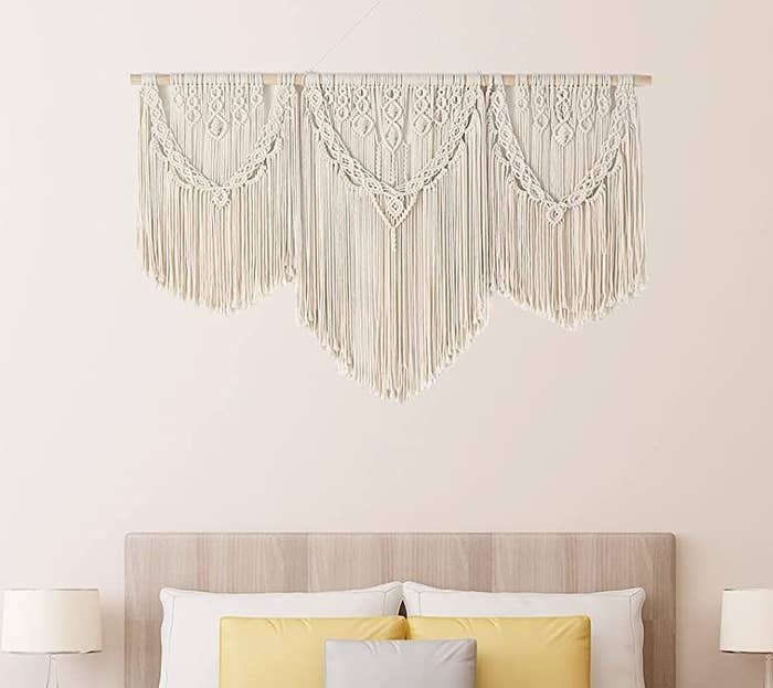 The wall hanging over a bed in a bedroom