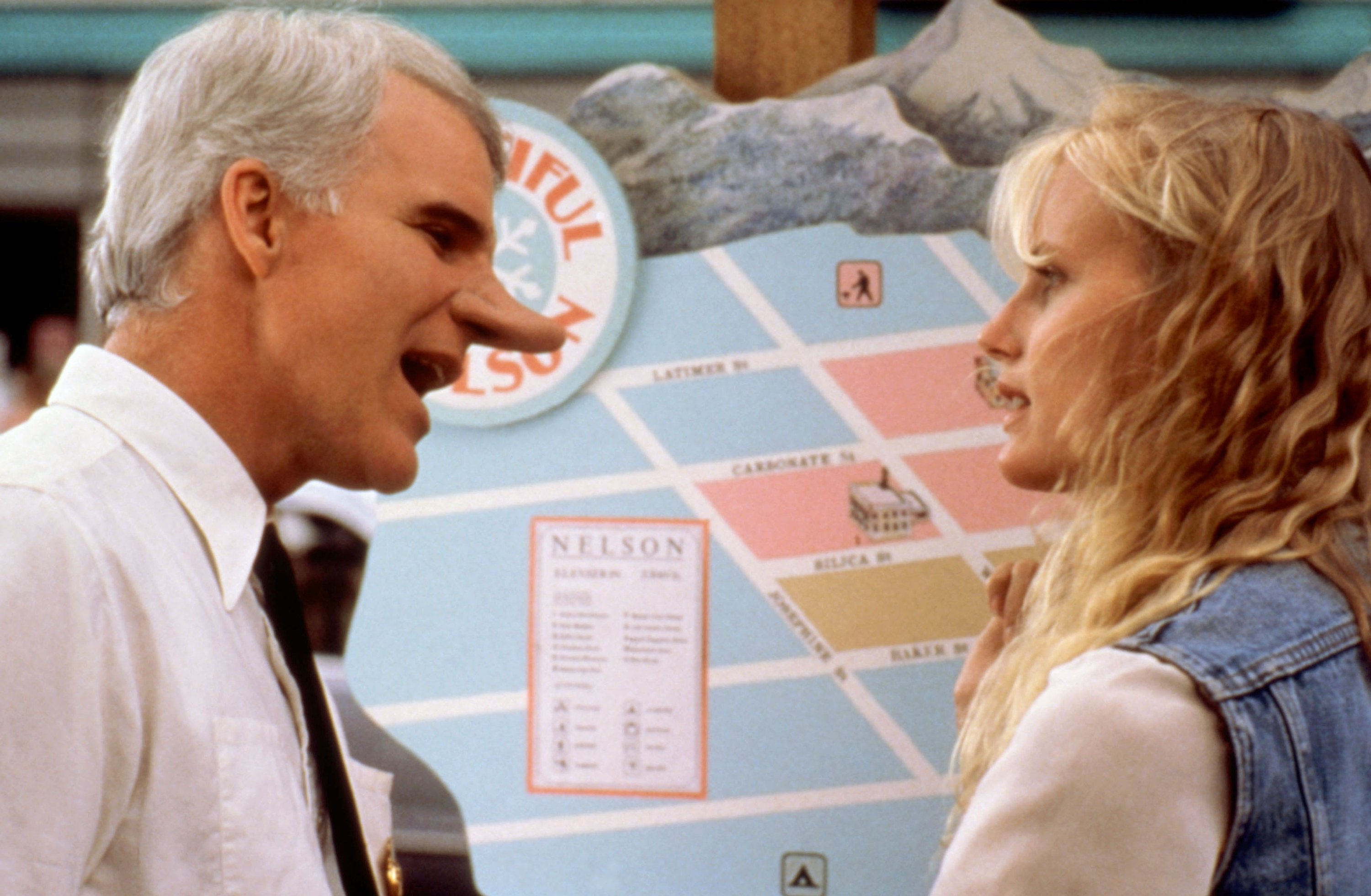 Steve Martin with a large nose screaming at a woman