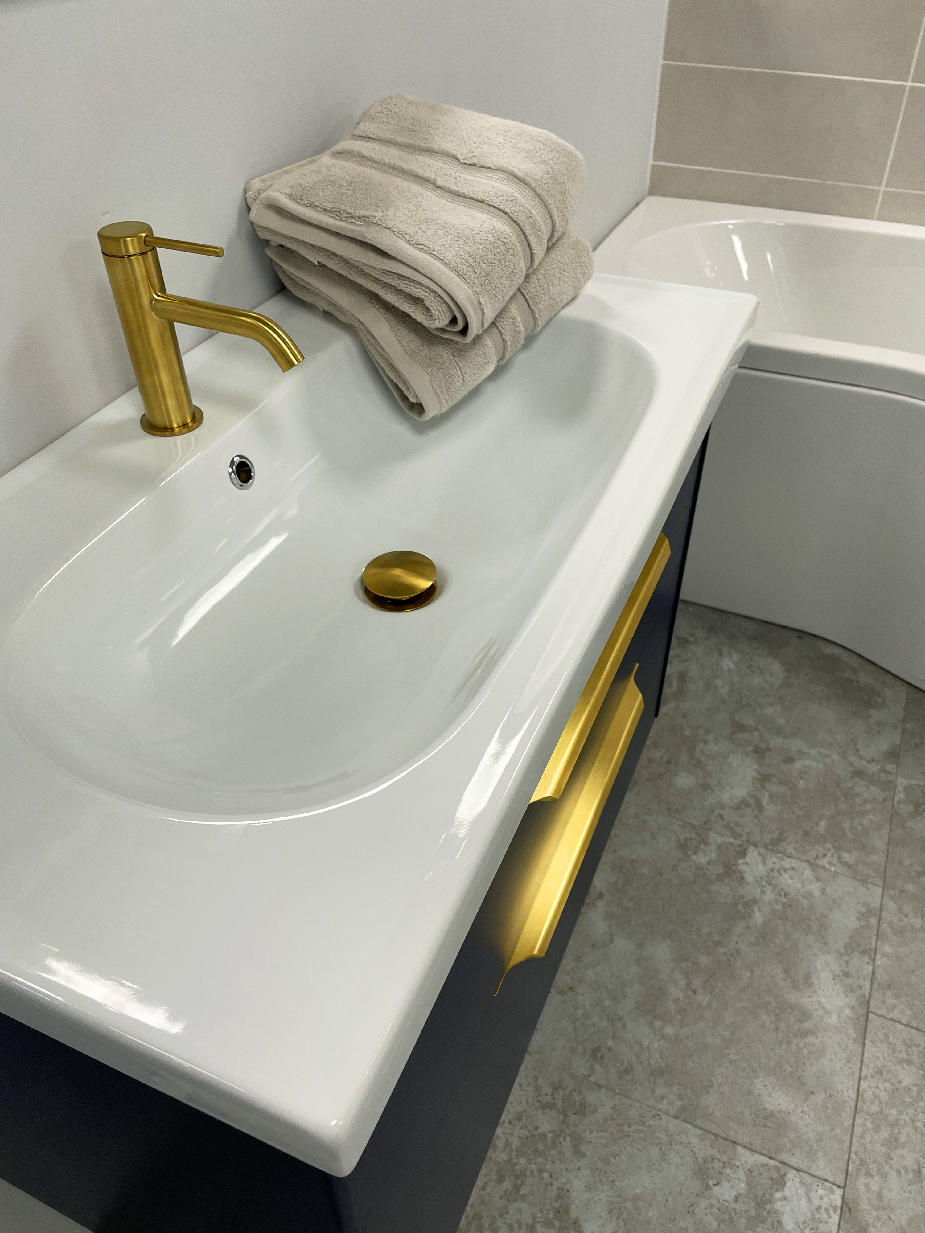 gold hardware on a porcelein bathroom vanity