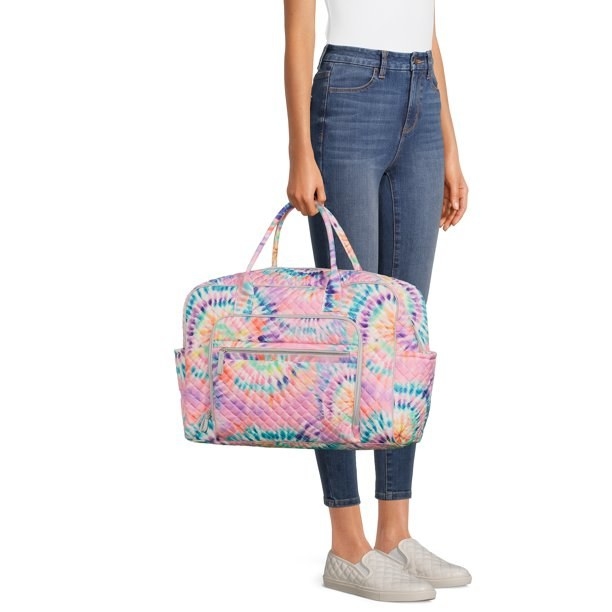 a model carrying the pink tie-dye bag
