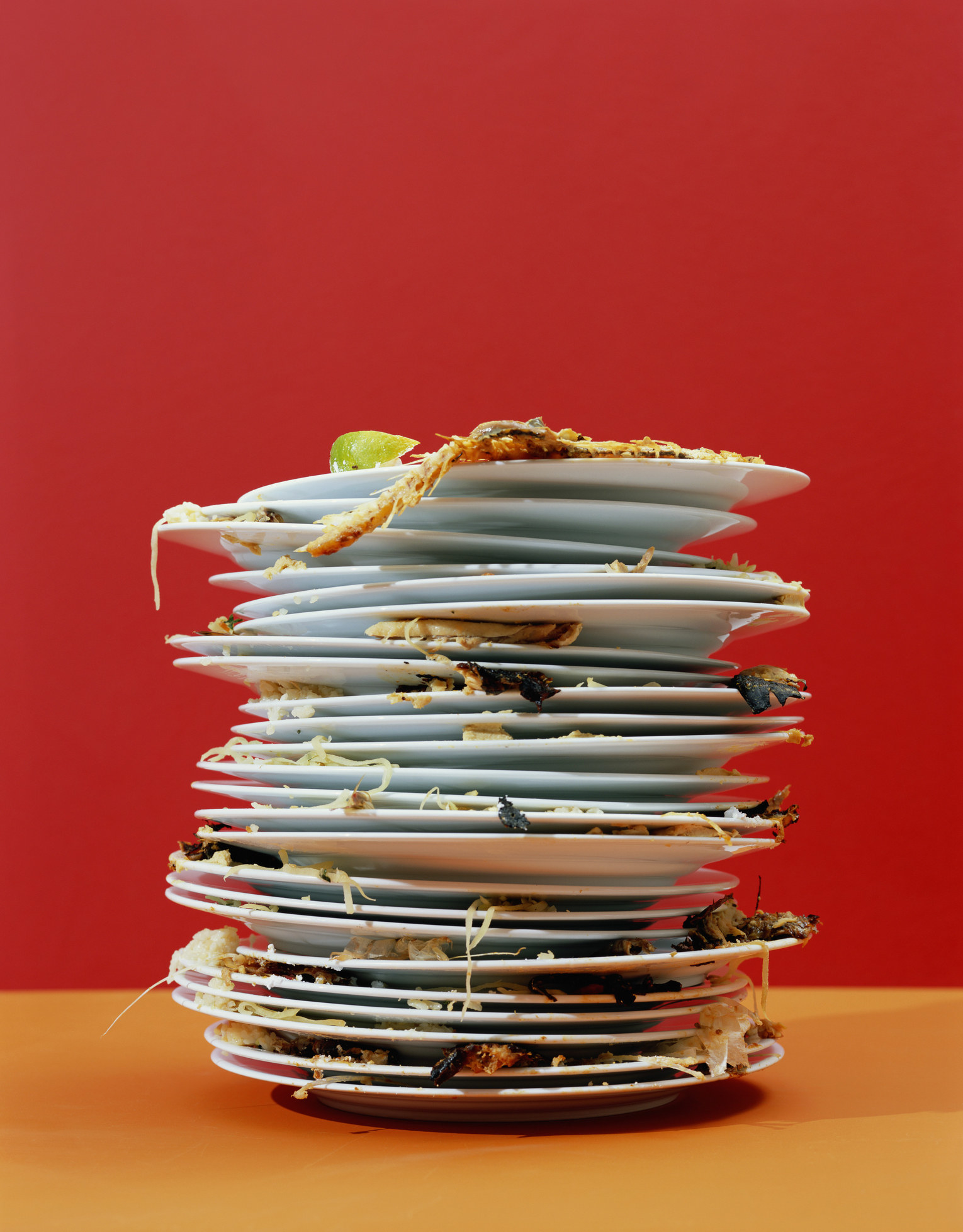 Many plates containing food stacked on top of one another