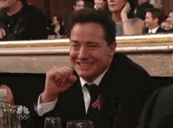 Brendan Fraser pointing, slapping his hands, and laughing