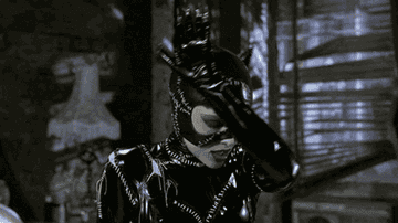 Catwoman cleaning herself in Batman Returns