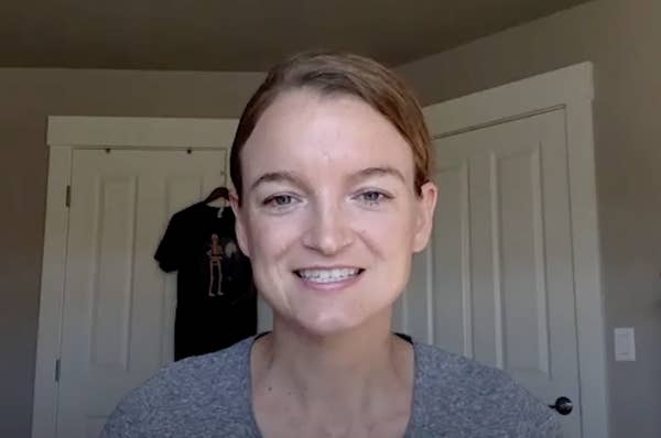 Headshot of woman with hair pulled back smiling into the camera