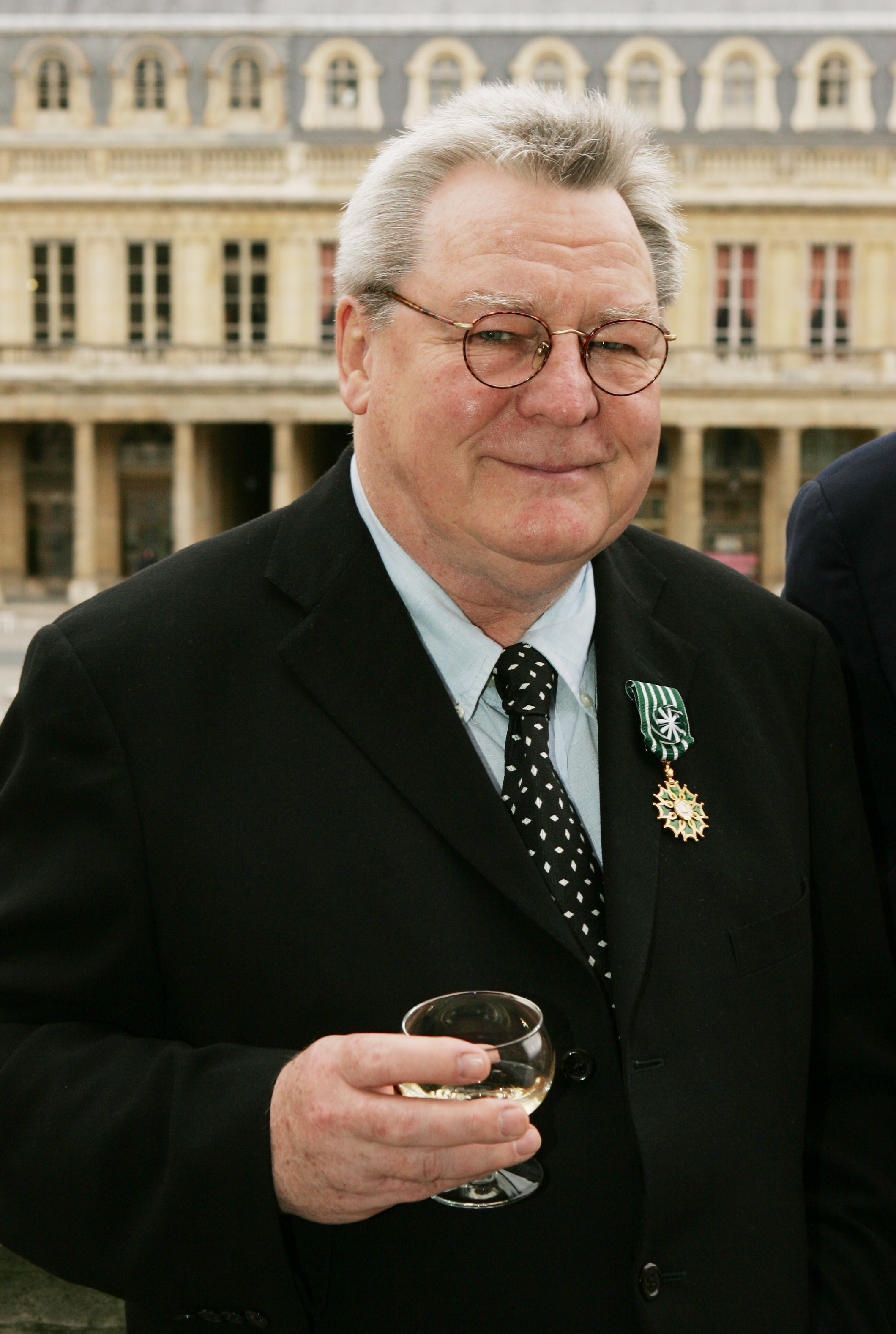 British film director Sir Alan Parker displays his &quot;Officier des Arts et Lettres&quot; medal awarded to him for his contribution to cinema