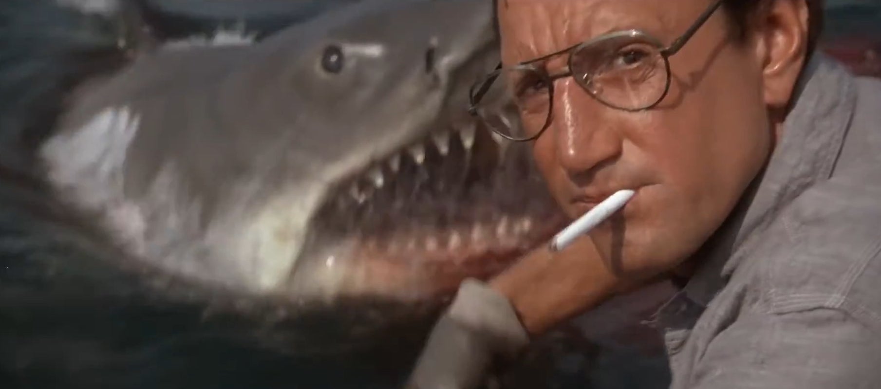 Brody smoking a cigarette with the shark behind him in &quot;Jaws&quot;