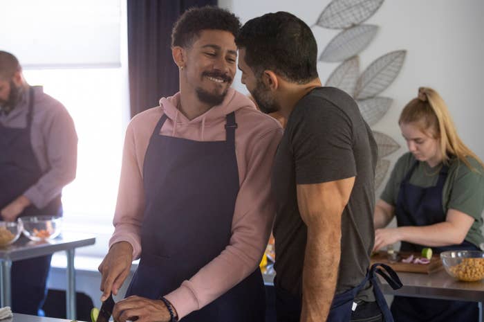 Keiynan Lonsdale cosies up to a guy whilst in a cooking class in a still from my fake boyfriend