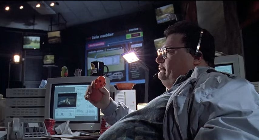 Dennis sitting at his desk in "Jurassic Park"