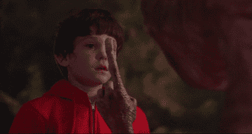 E.T&#x27;s finger lights up in front of Henry Thomas as Elliott Taylor in &quot;E.T. The Extra-Terrestrial&quot;