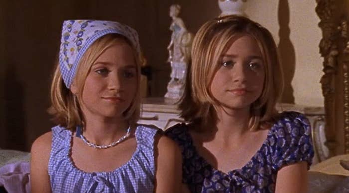 Mary Kate and Ashley sit together while looking at someone