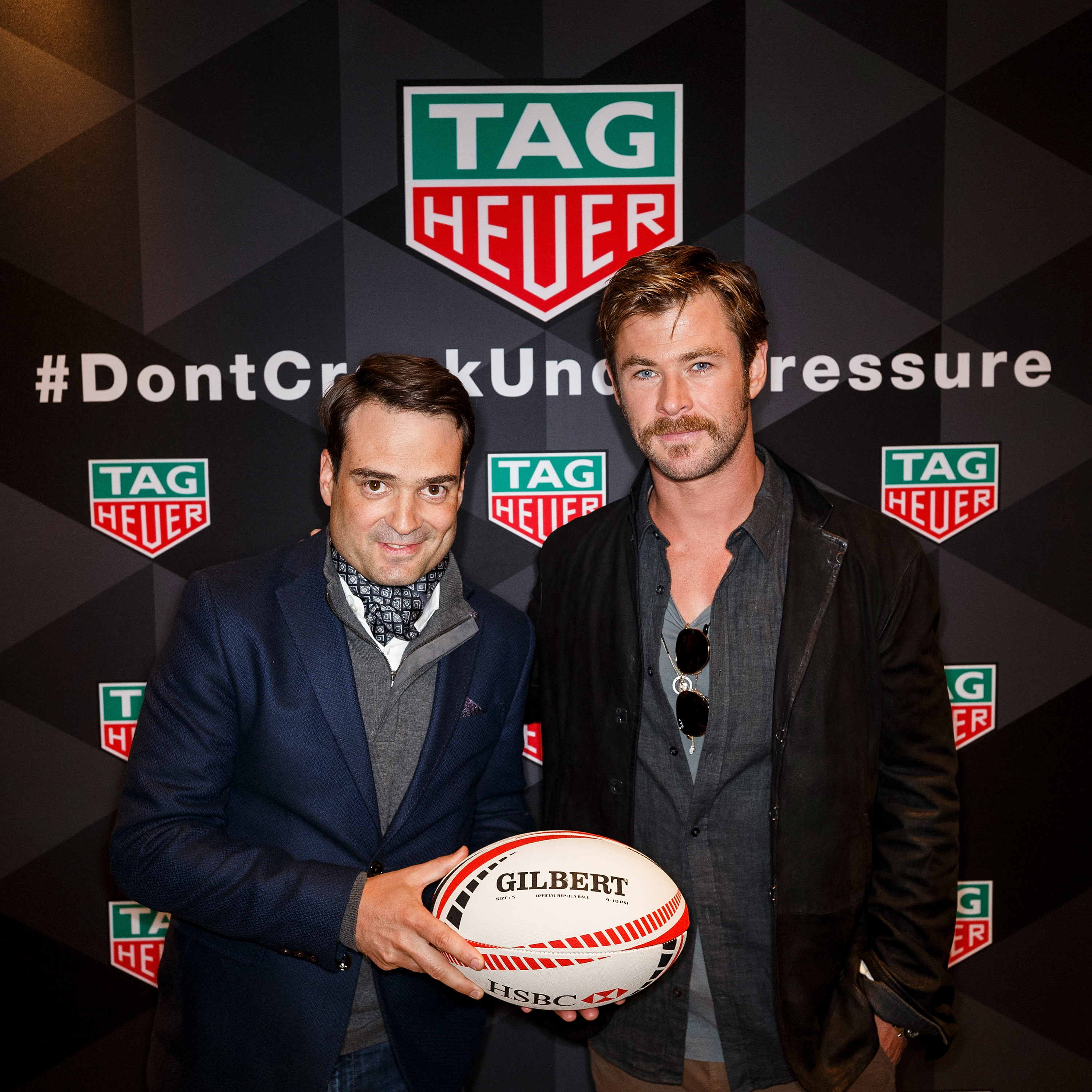 TAG Heuer President North America Kilian Muller (L) and TAG Heuer Ambassador Chris Hemsworth pose after TAG Heuer donates money to indigenous youth rugby programs