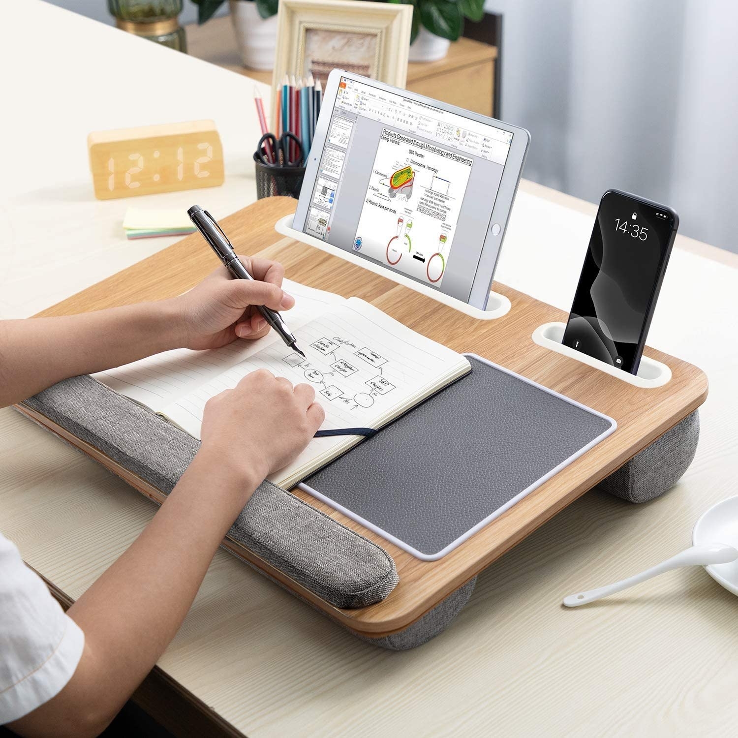 A person using the lap desk on a desk