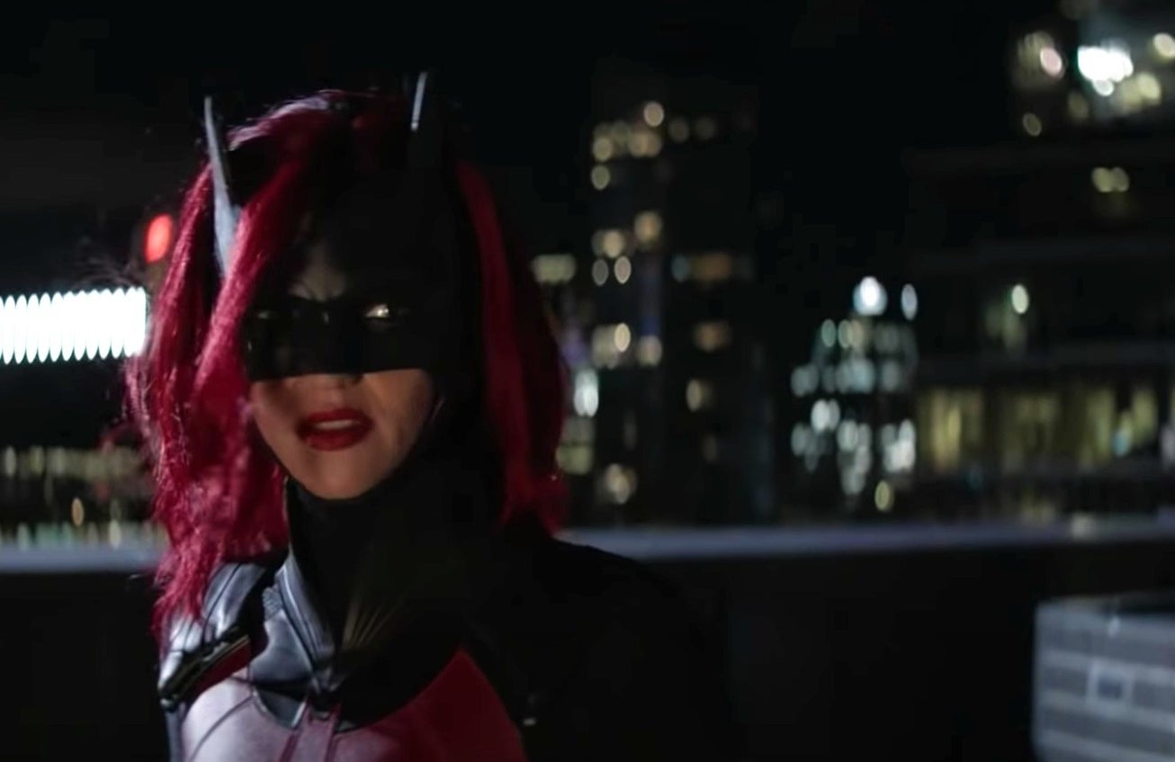 Ruby Rose as Batwoman, with red hair and a mask.