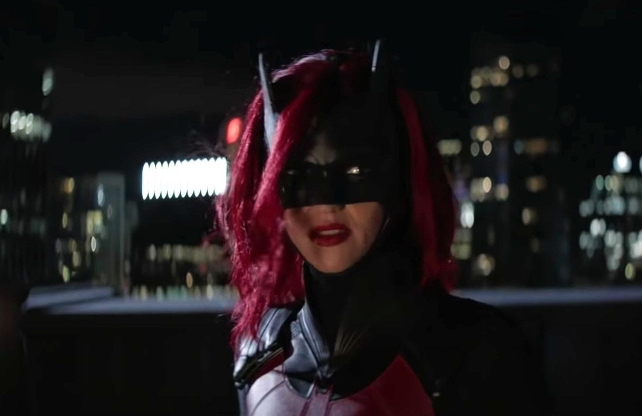 Ruby Rose as Batwoman, with red hair and a mask.
