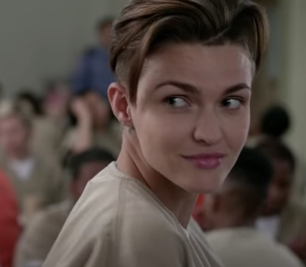 Ruby Rose with a short haircut in a prison uniform.