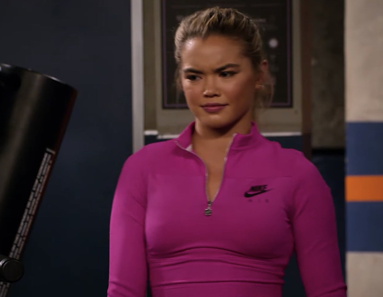Paris Berelc in a pink sports sweater looking confused.
