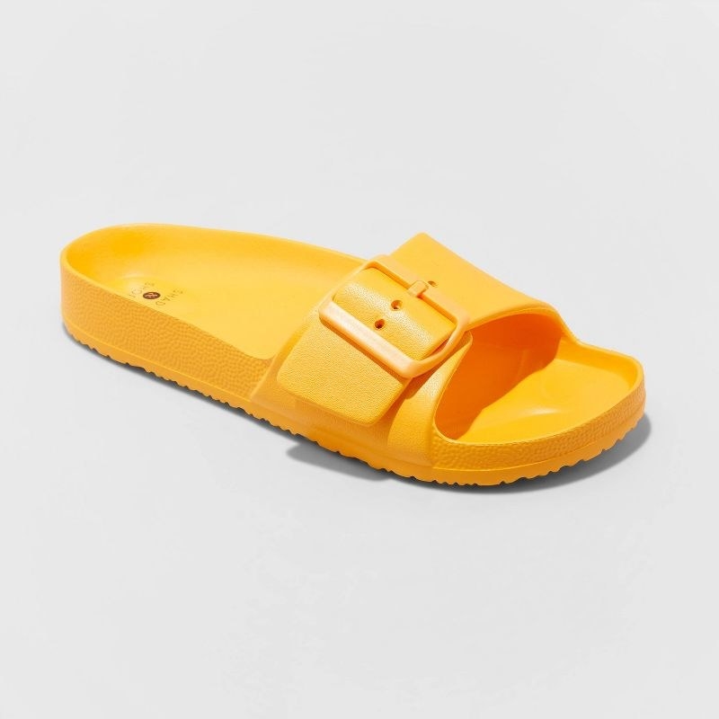 yellow slide sandals with one strap with a buckle